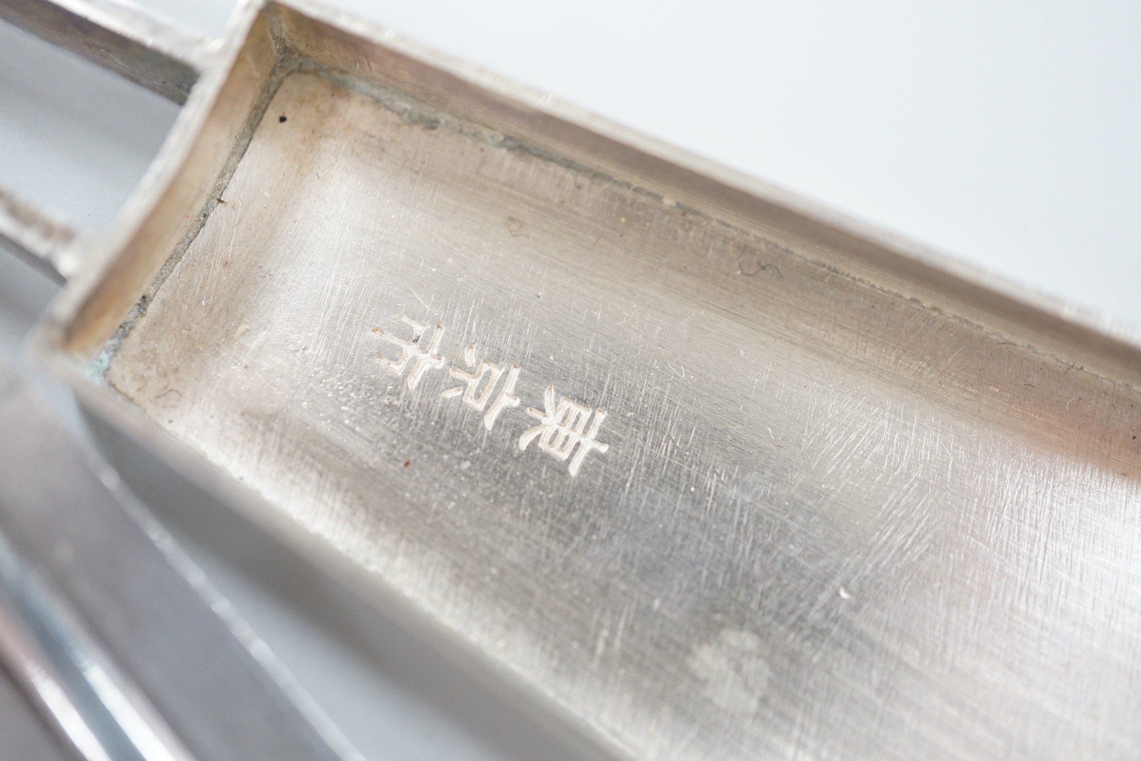 A 20th century Japanese white metal pill box, modelled as a fan with sliding panel, signed, 11.4cm.